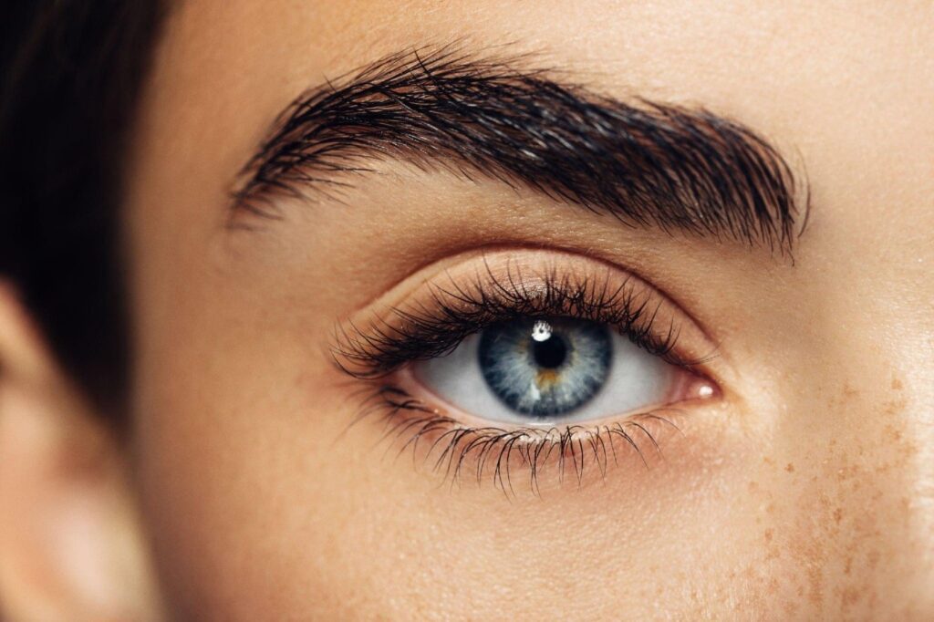 A close-up photo of a woman's face with beautiful, expressive eyes and brows. Eyebrow Treatment In Delhi