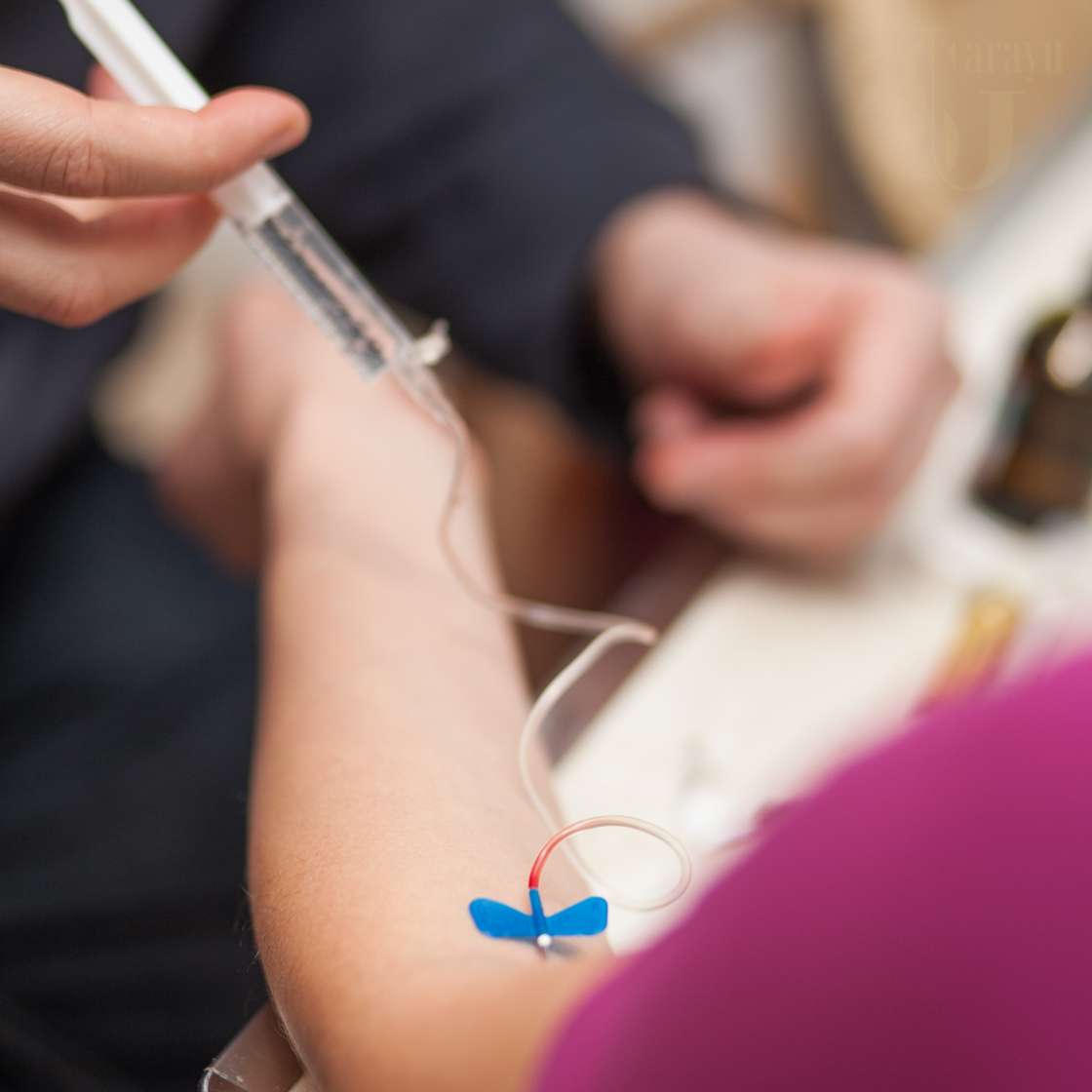 Patient receiving Glutathione IV drip in Delhi at Sarayu Clinics, administered by Dr. Adarsh Tripathi for skin brightening and detoxification.